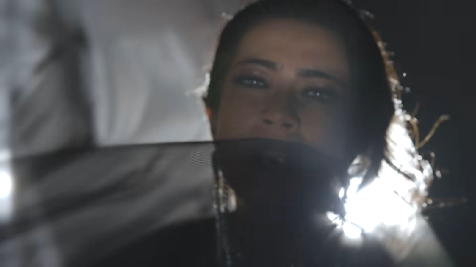 Close portrait of Devika with a sheer veil across her face.